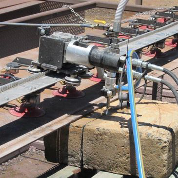 A machine is cutting a piece of metal with water.