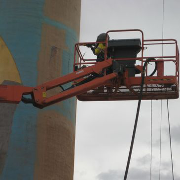 A man on a crane with the letter d on it