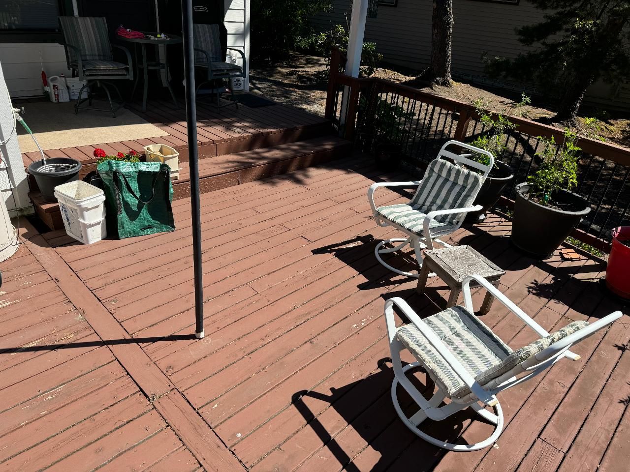 A wooden deck with two rocking chairs on it