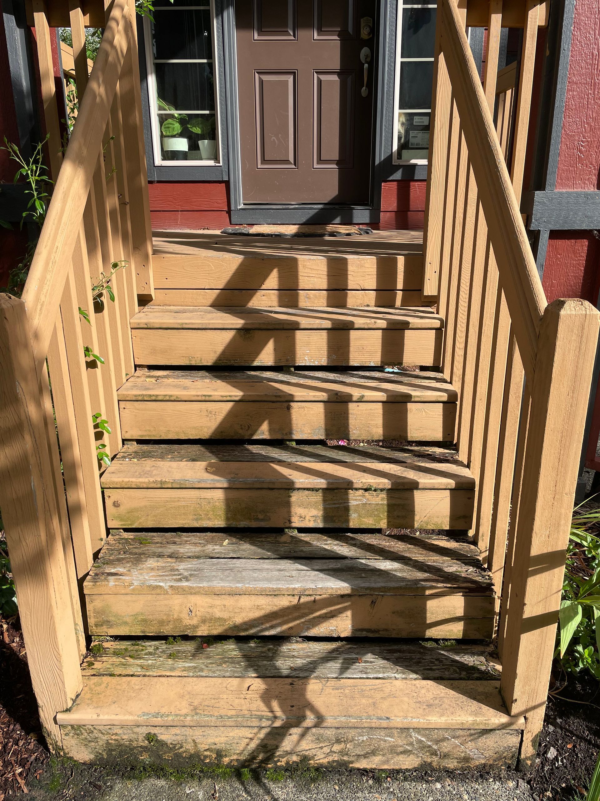 A set of wooden stairs leading up to a house.