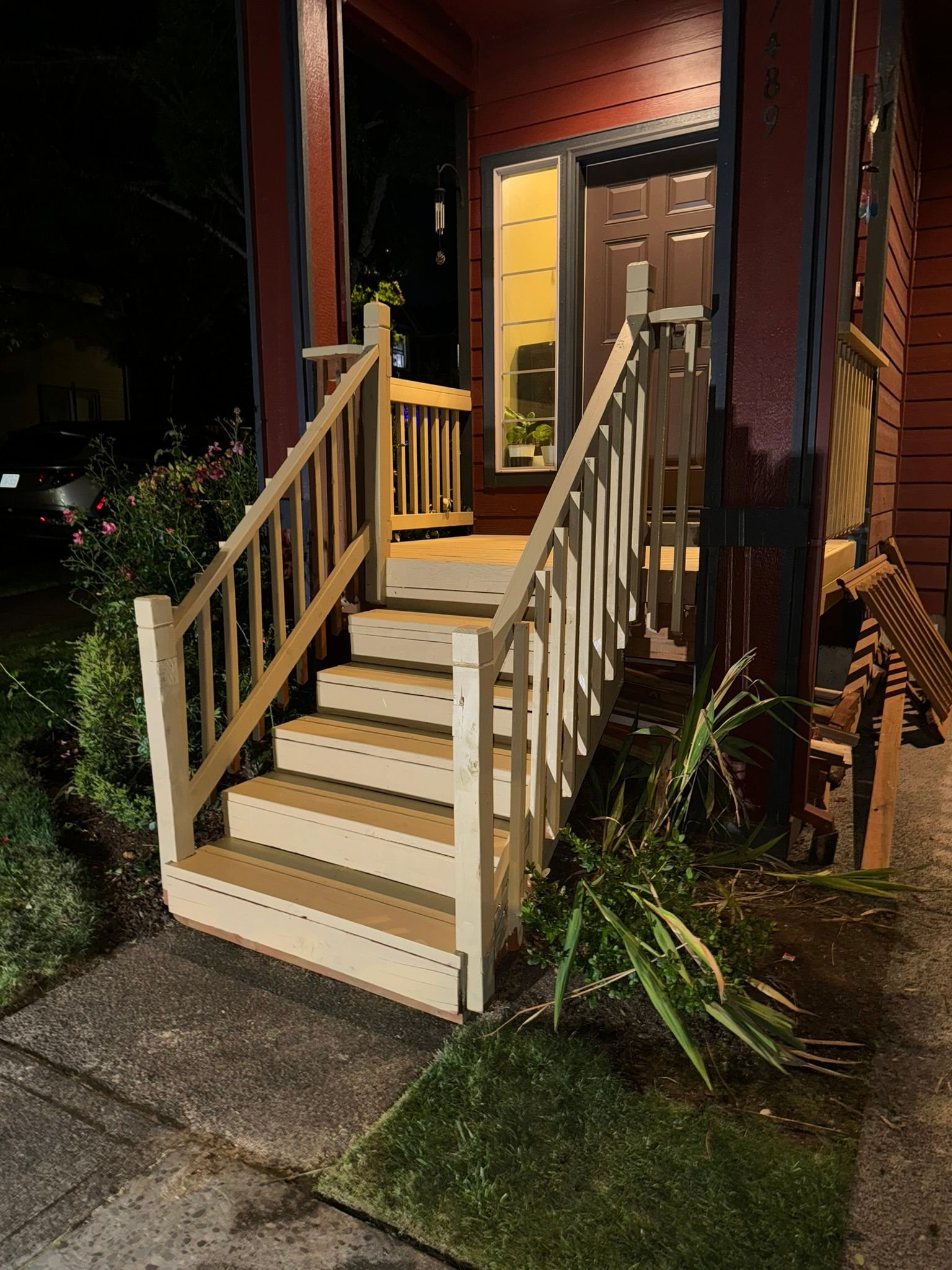 A set of stairs leading up to a house at night.