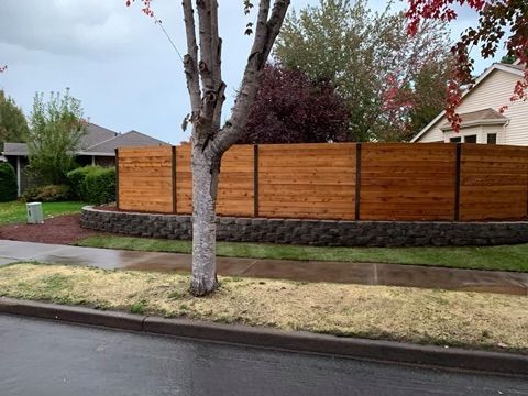 A wooden fence with a tree in the middle of it