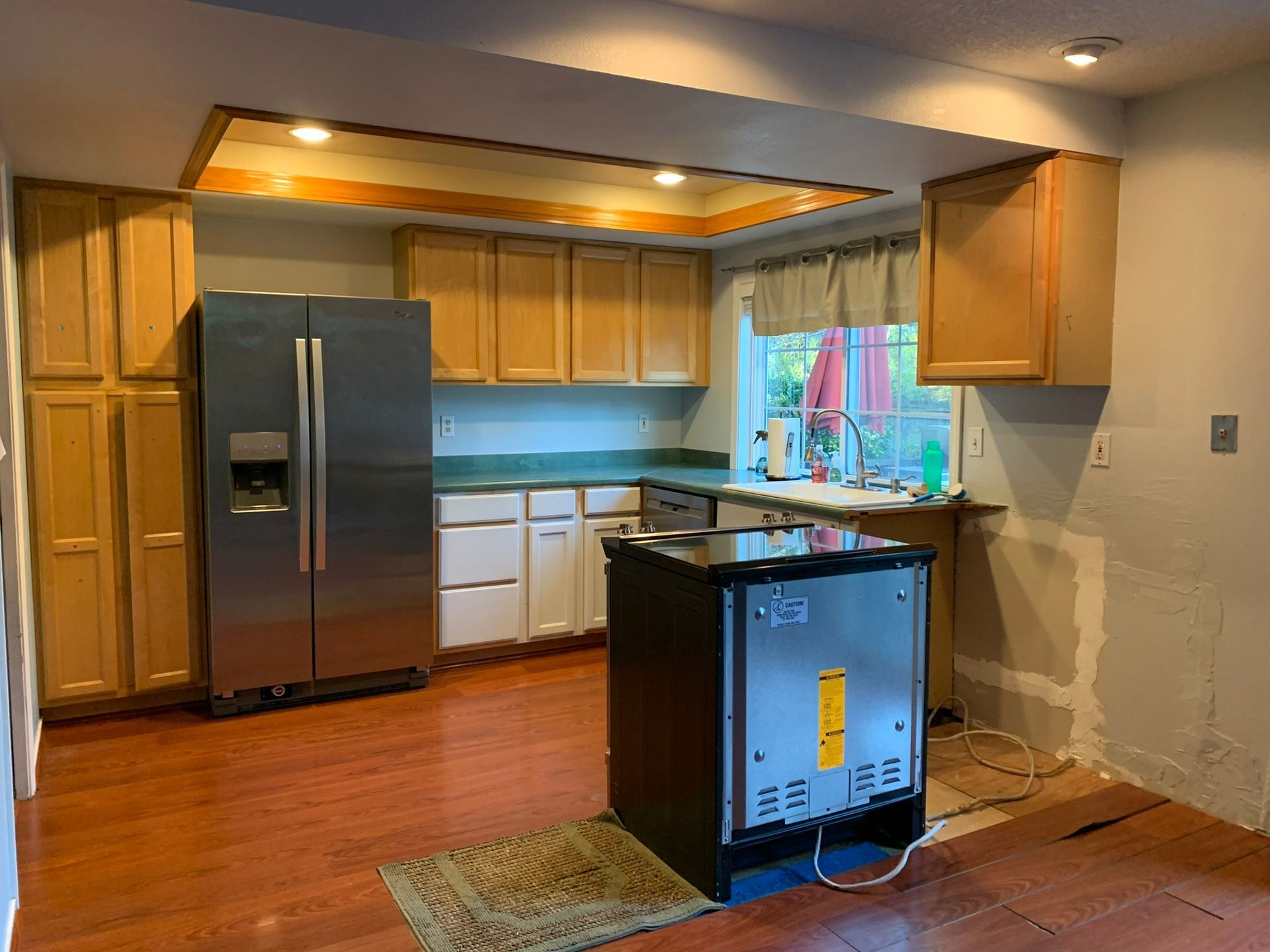 A kitchen with stainless steel appliances and wooden cabinets