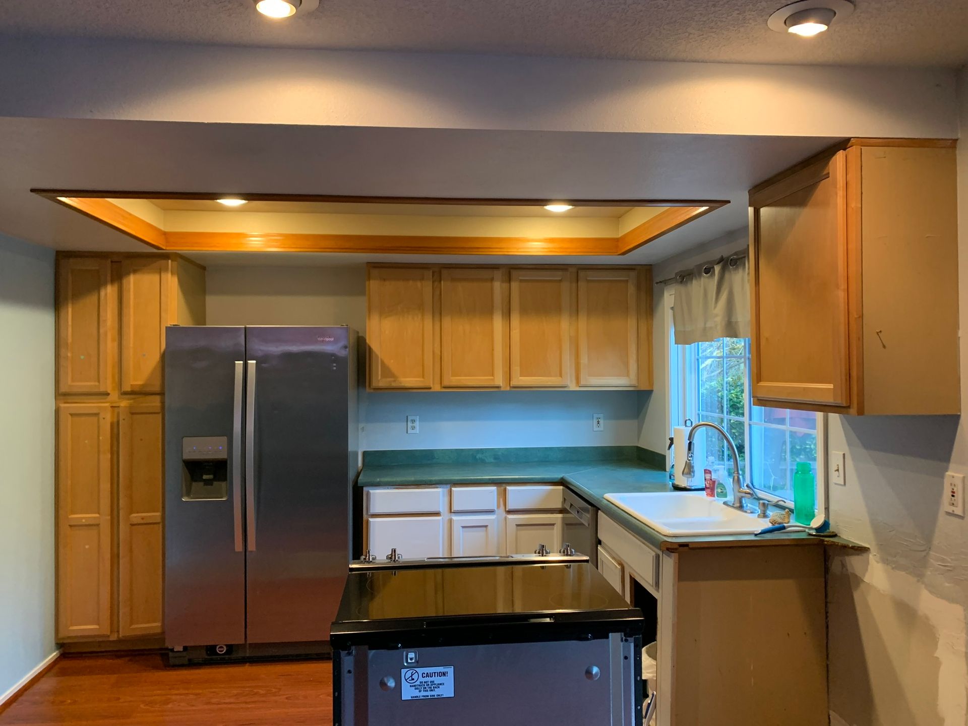 A kitchen with stainless steel appliances and wooden cabinets