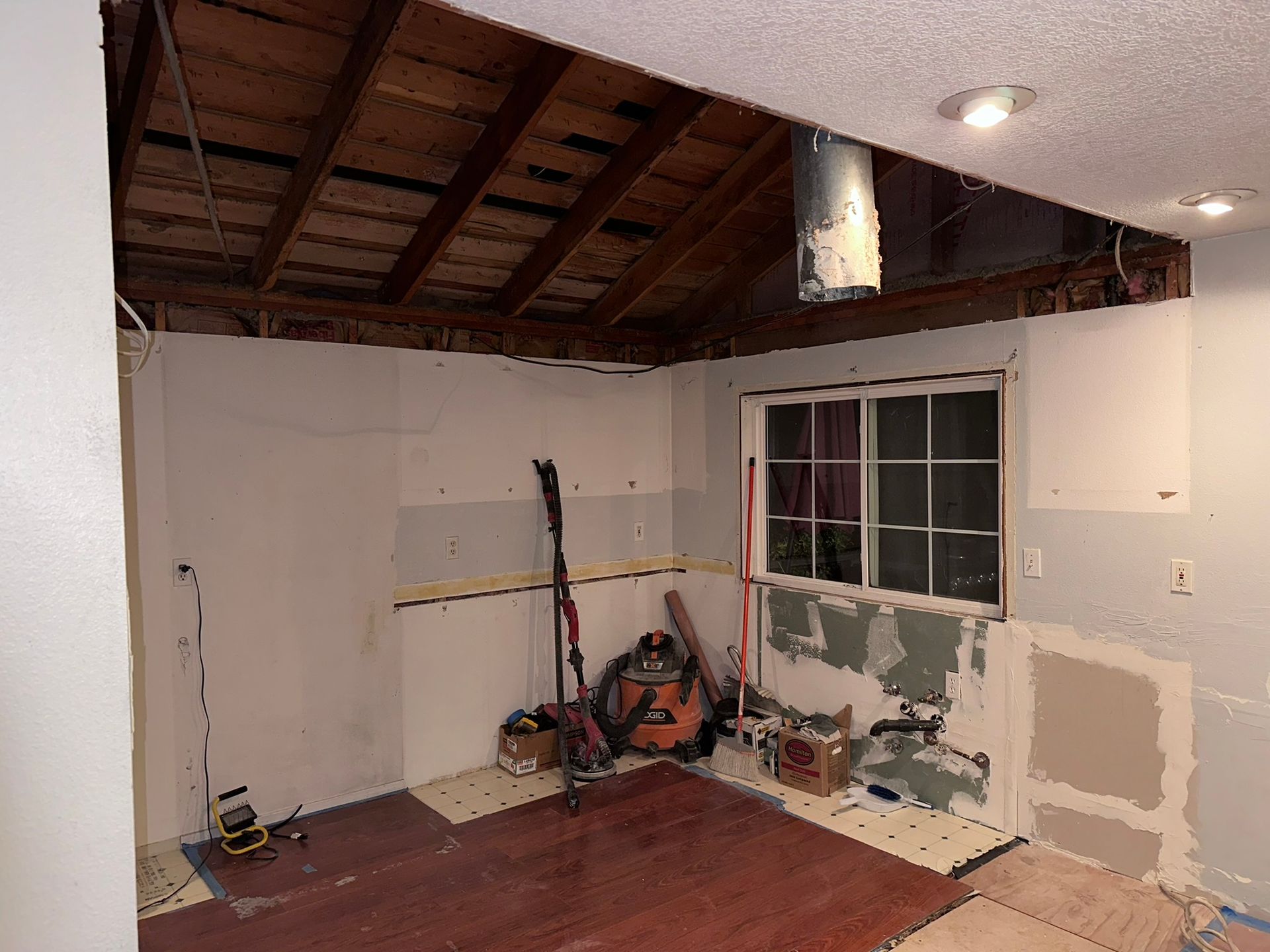 A room with a window and a ceiling that is being remodeled