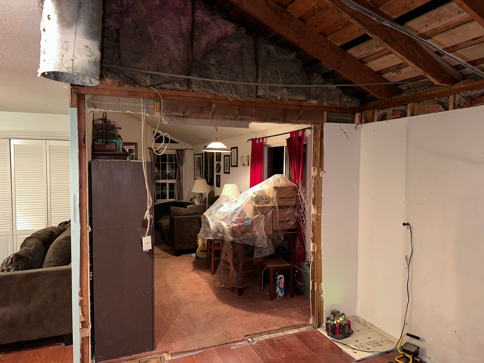A living room with a couch , chairs , and a refrigerator.
