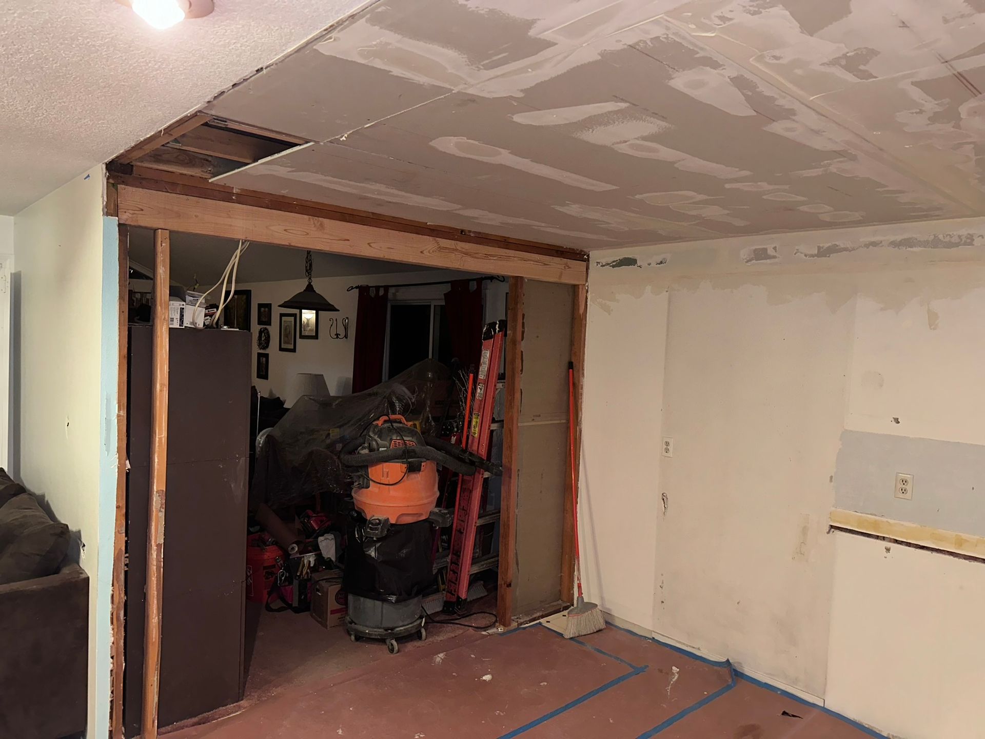 A room with a sliding glass door and a vacuum cleaner in it.