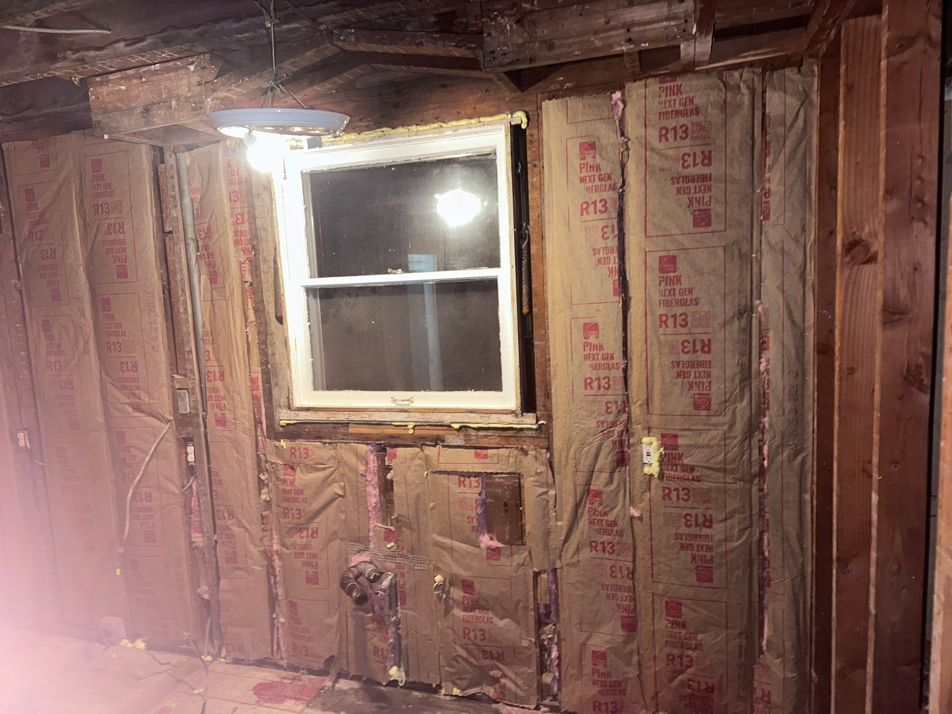 A room with a window and a lot of insulation on the wall.