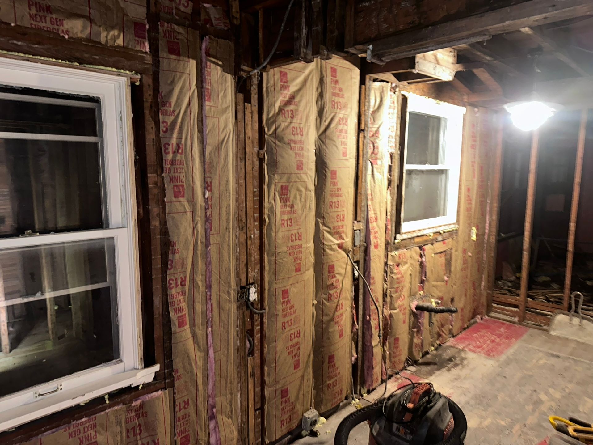 A room with a lot of insulation on the walls and a window.