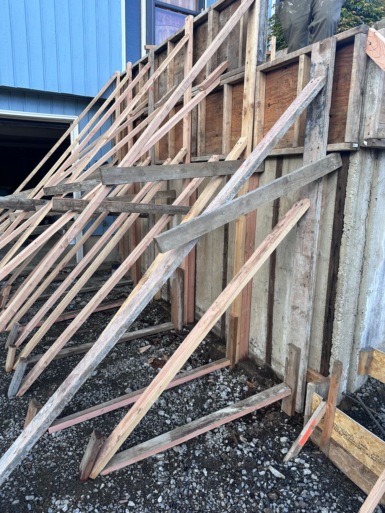A wooden fence is being built in front of a building.