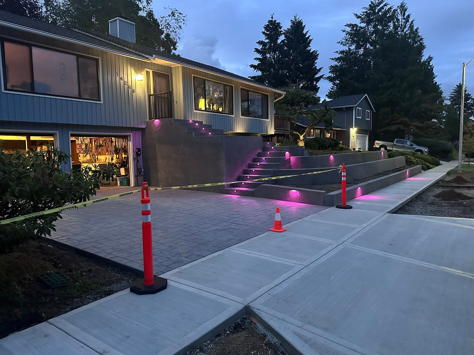 A house with stairs leading up to it is lit up with pink lights