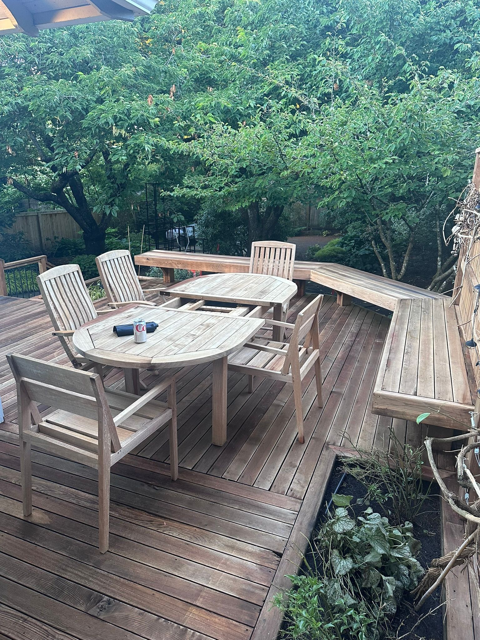 A wooden deck with a table and chairs on it.