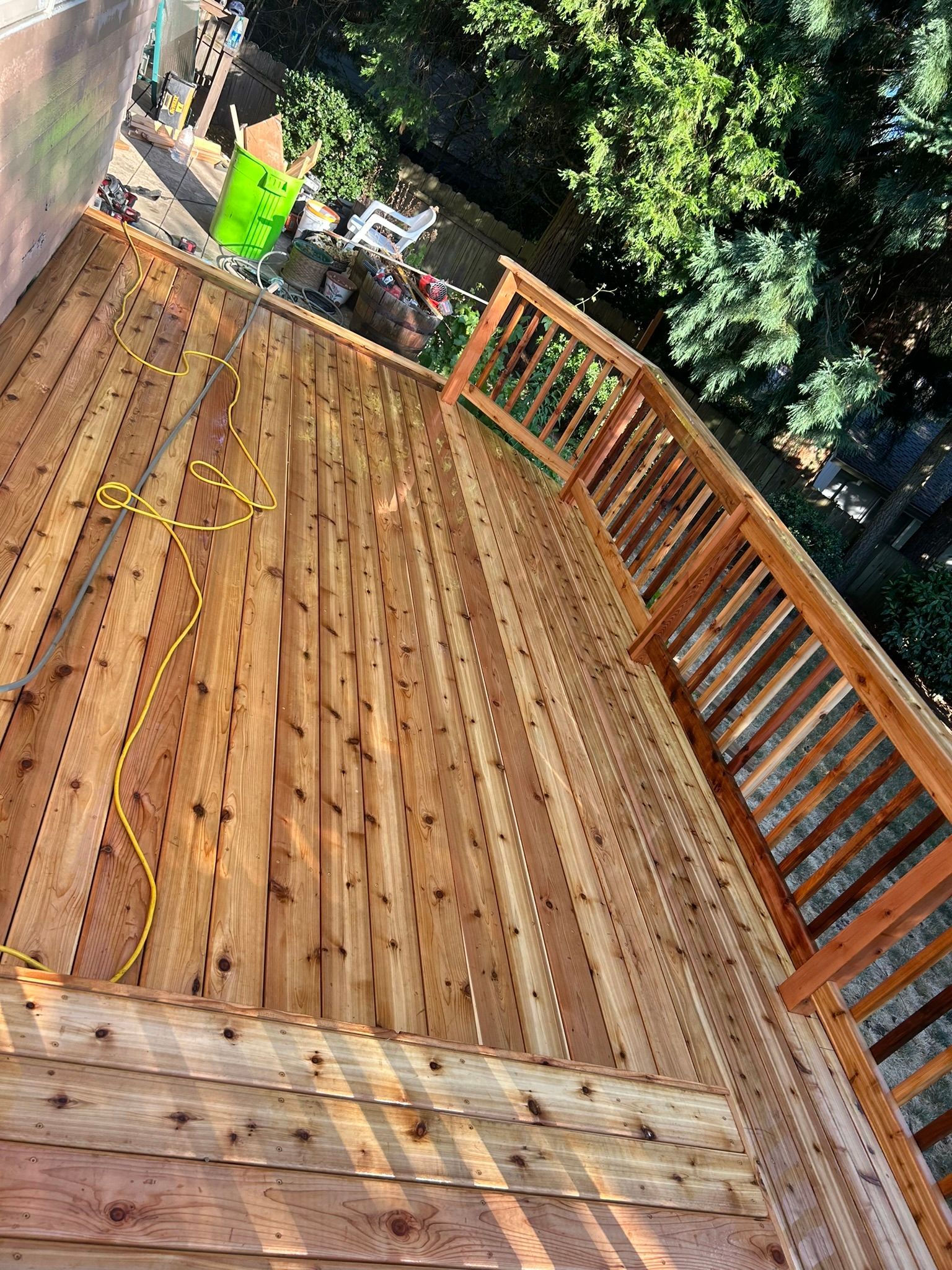 A man is standing on top of a wooden deck.