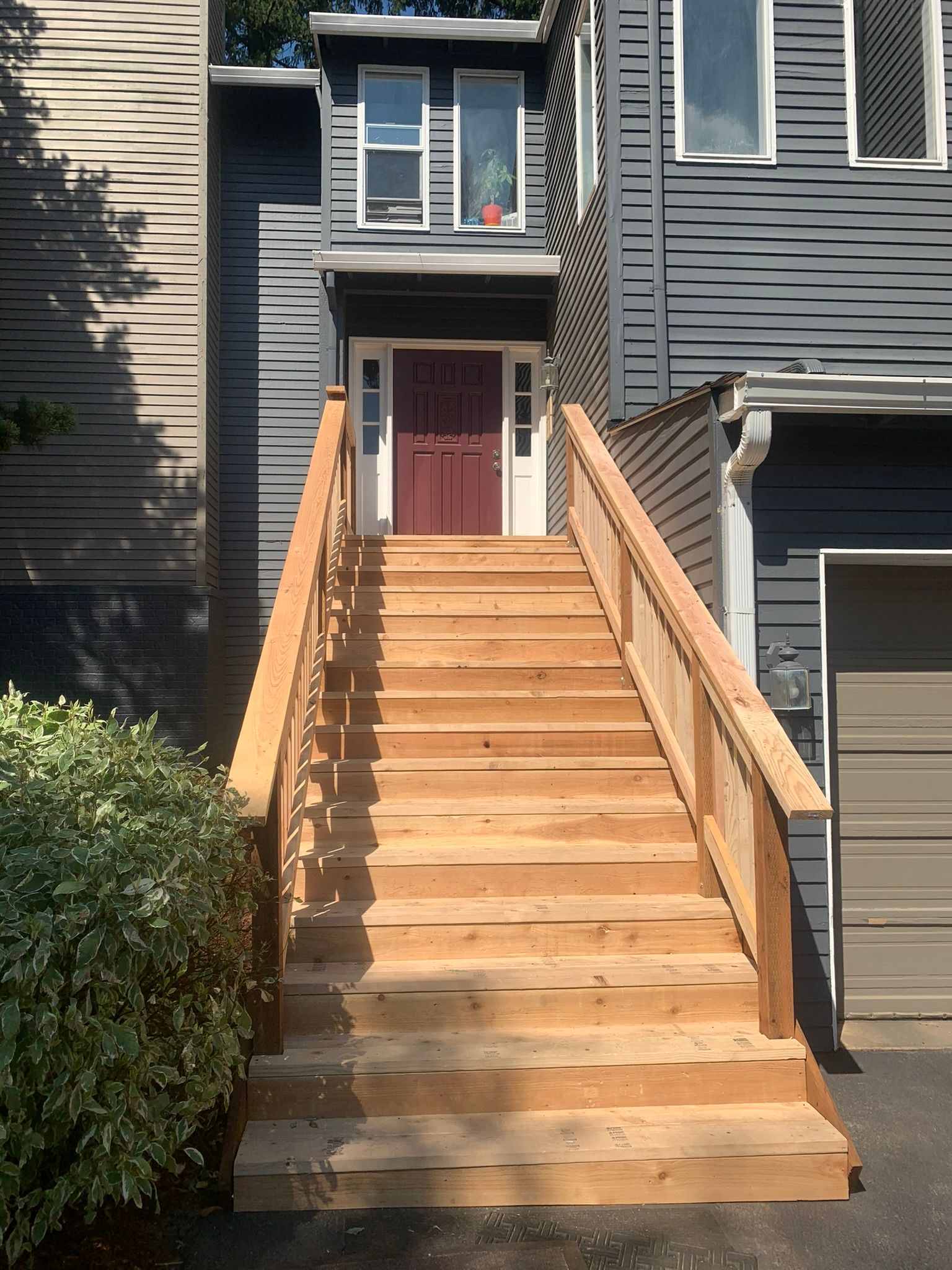 A wooden staircase leading up to the front door of a house