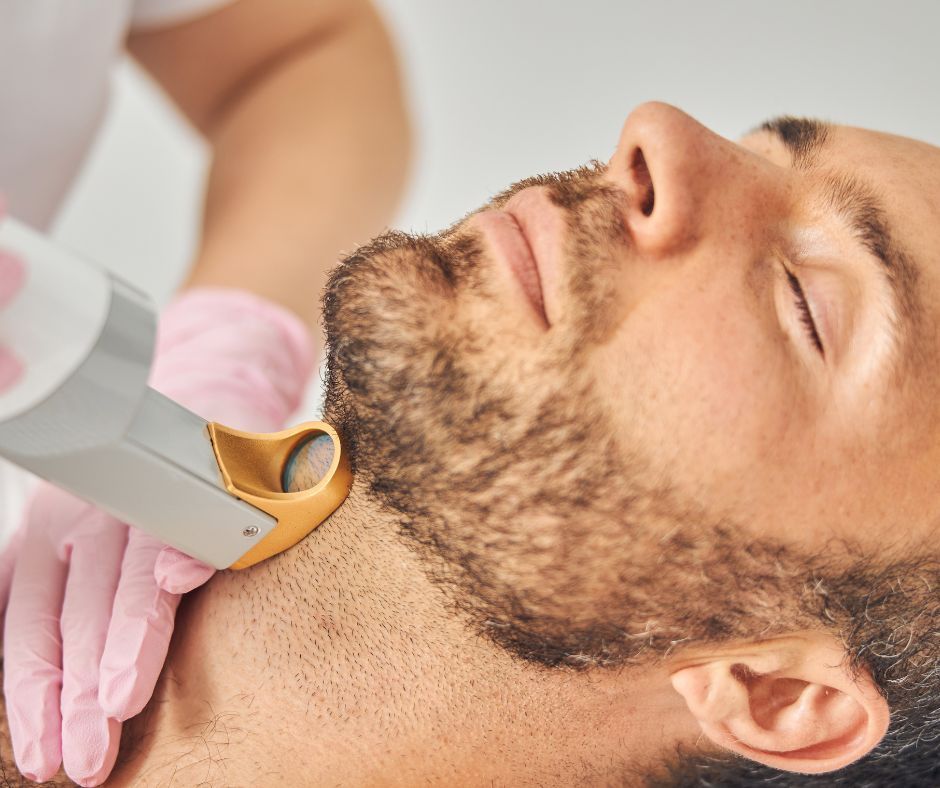 A Person In Pink Gloves Uses A Laser Device — Hope Laser and Beauty Clinic in Forster, NSW