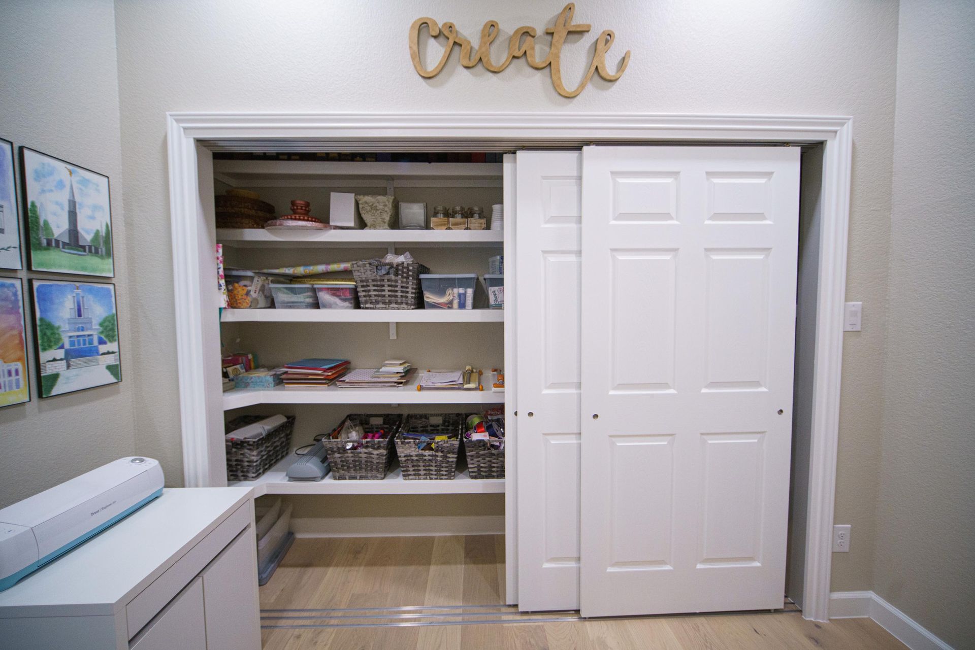 Craft room closet with shelves and sliding doors; craft supplies visible, work table on left.