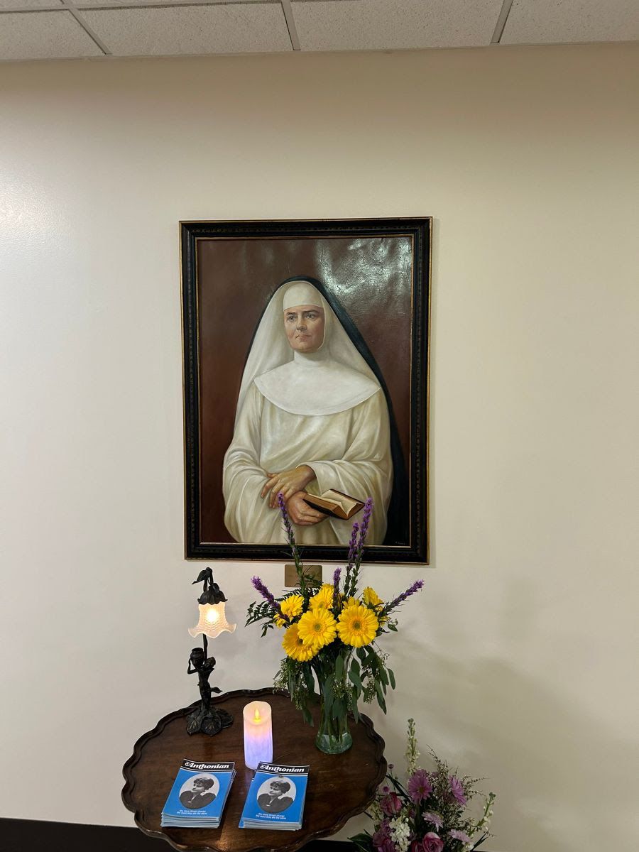 Painting of Mother Rose Hawthorne, with flowers and candles at the Dominican Sisters of Hawthorne motherhouse