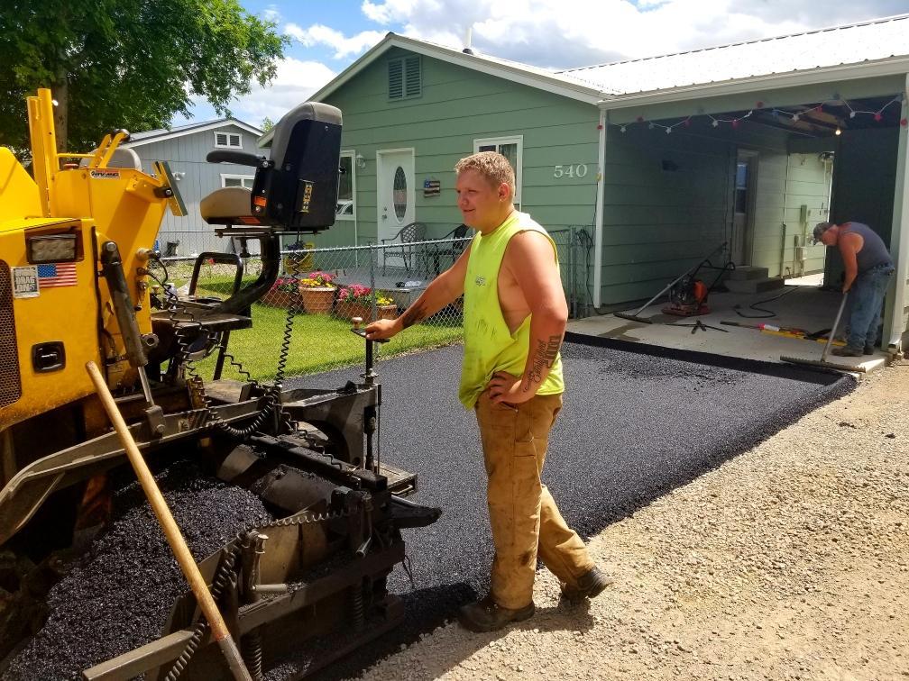 PaveCo Employee laying Asphalt