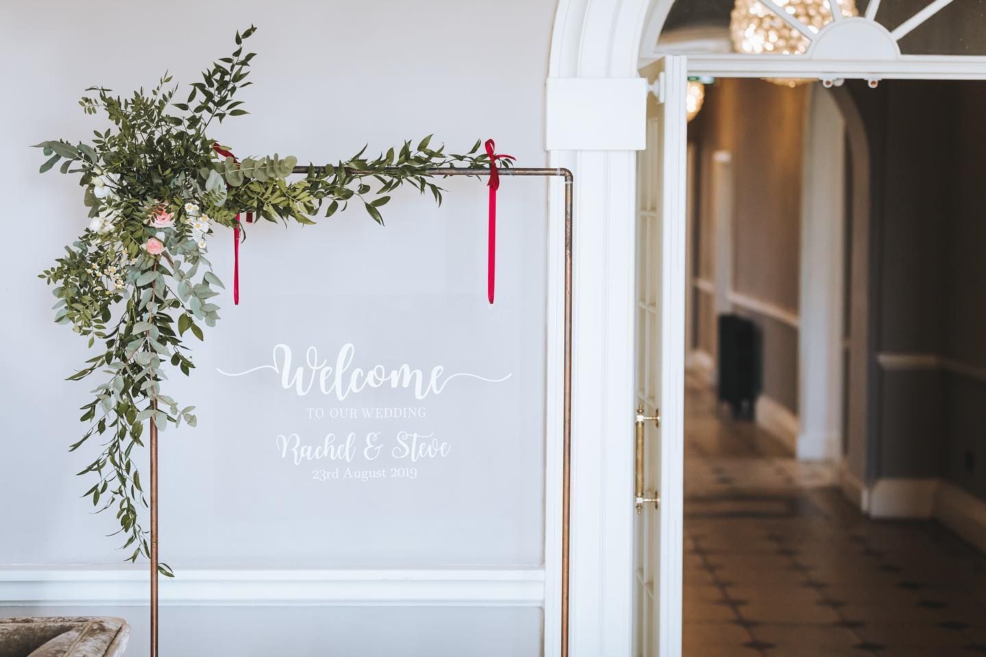 a welcome sign is hanging on a wall in a hallway .