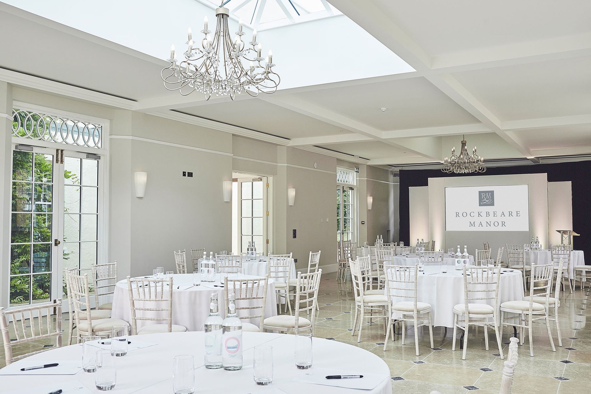 a large room with tables and chairs set up for a banquet .