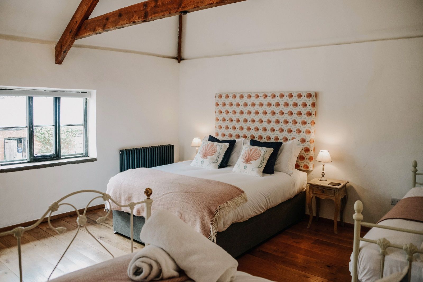 a bedroom with a large bed and two twin beds .