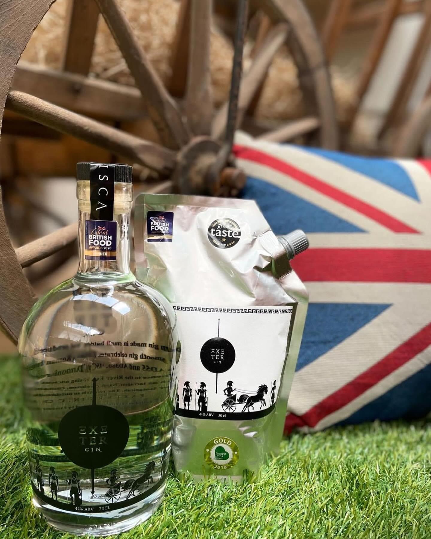 A bottle of alcohol is sitting next to a bag of alcohol.