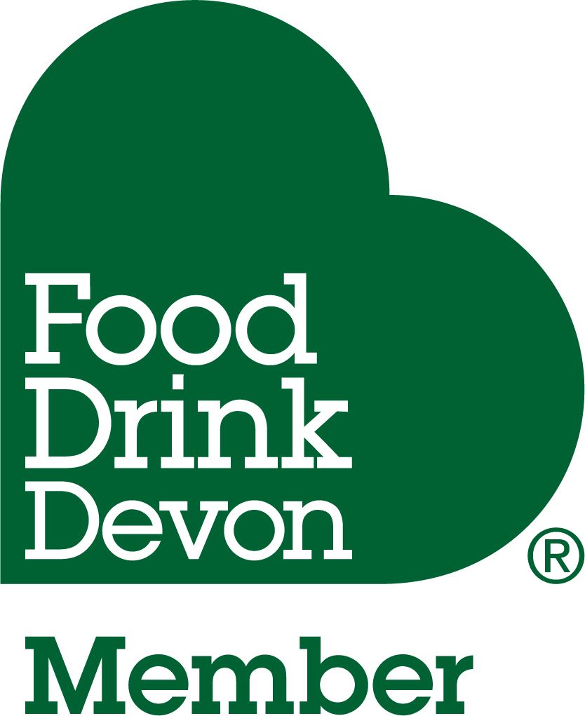 a green heart with the words `` food drink devon member '' written on it .
