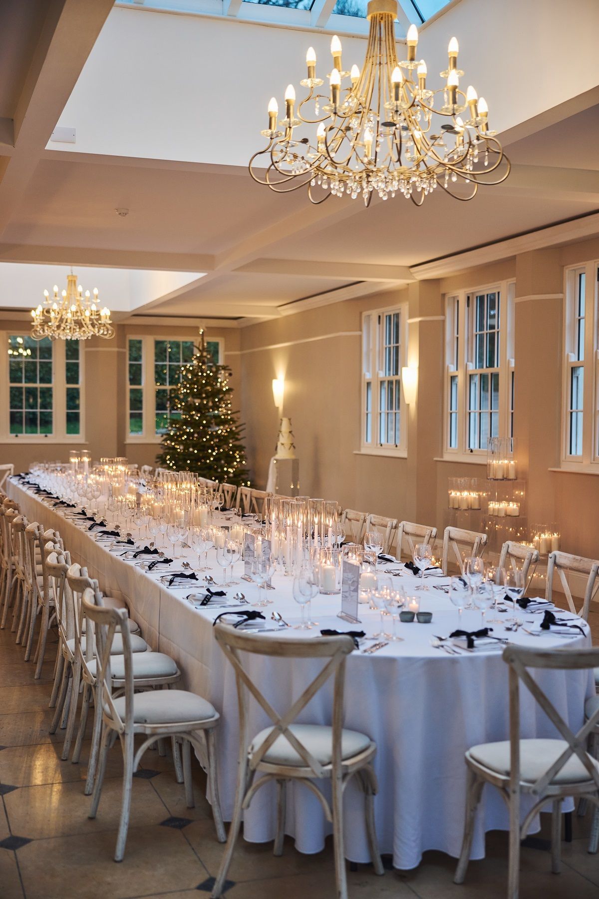 a black and white photo of a bride and groom walking in a field .