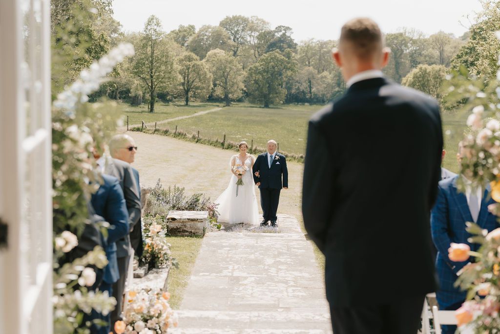 a bride and groom are sitting at a table signing a wedding register .