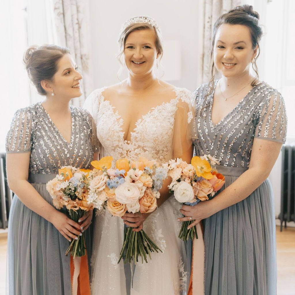 a bride and groom are sitting at a table signing a wedding register .