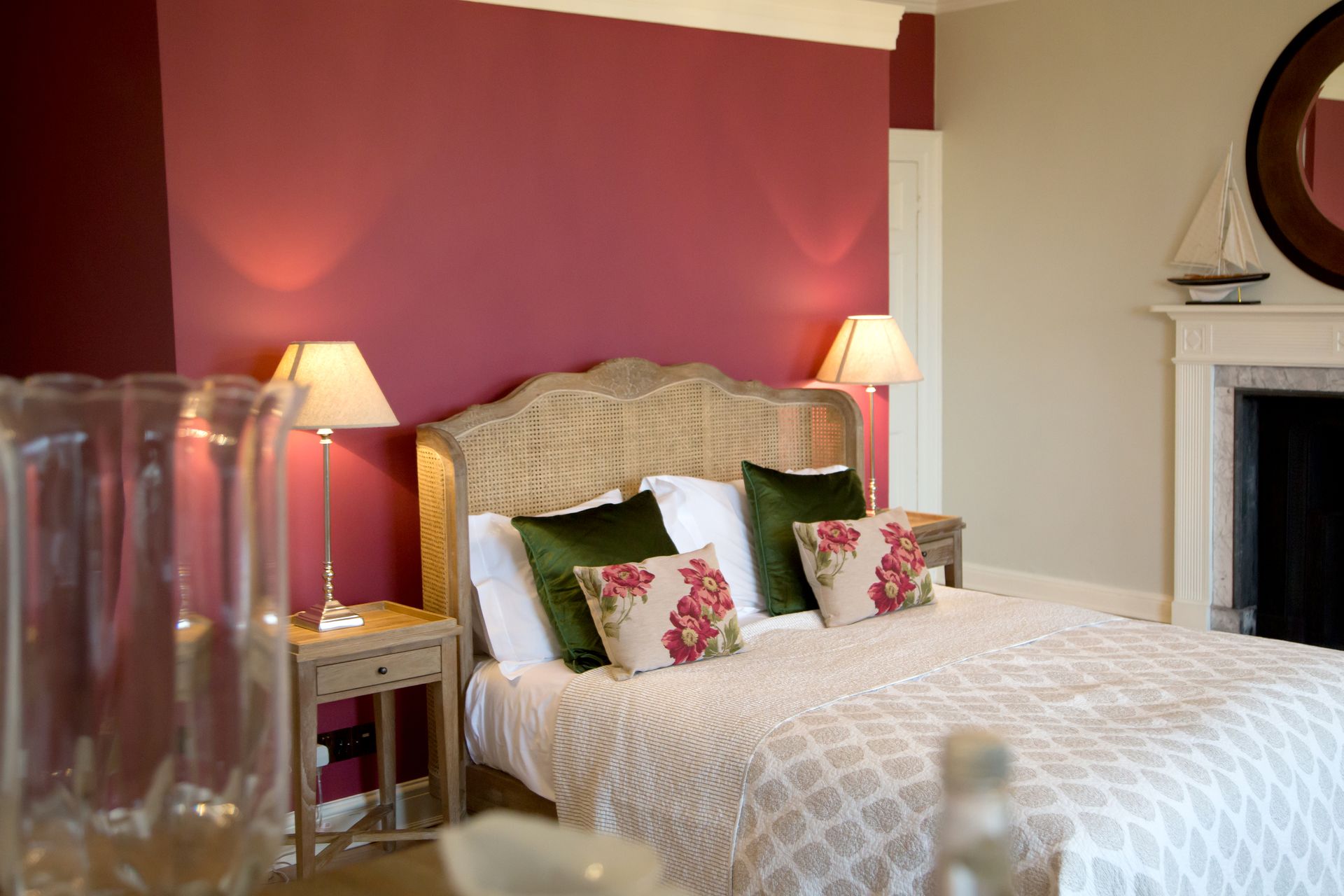 a bedroom with a large bed and a fireplace