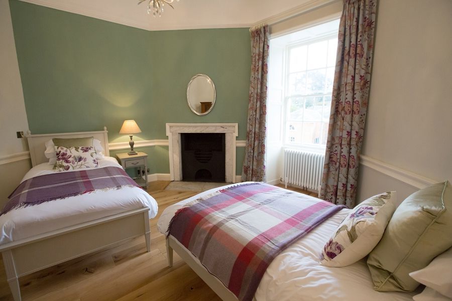 a bedroom with two beds and a fireplace .