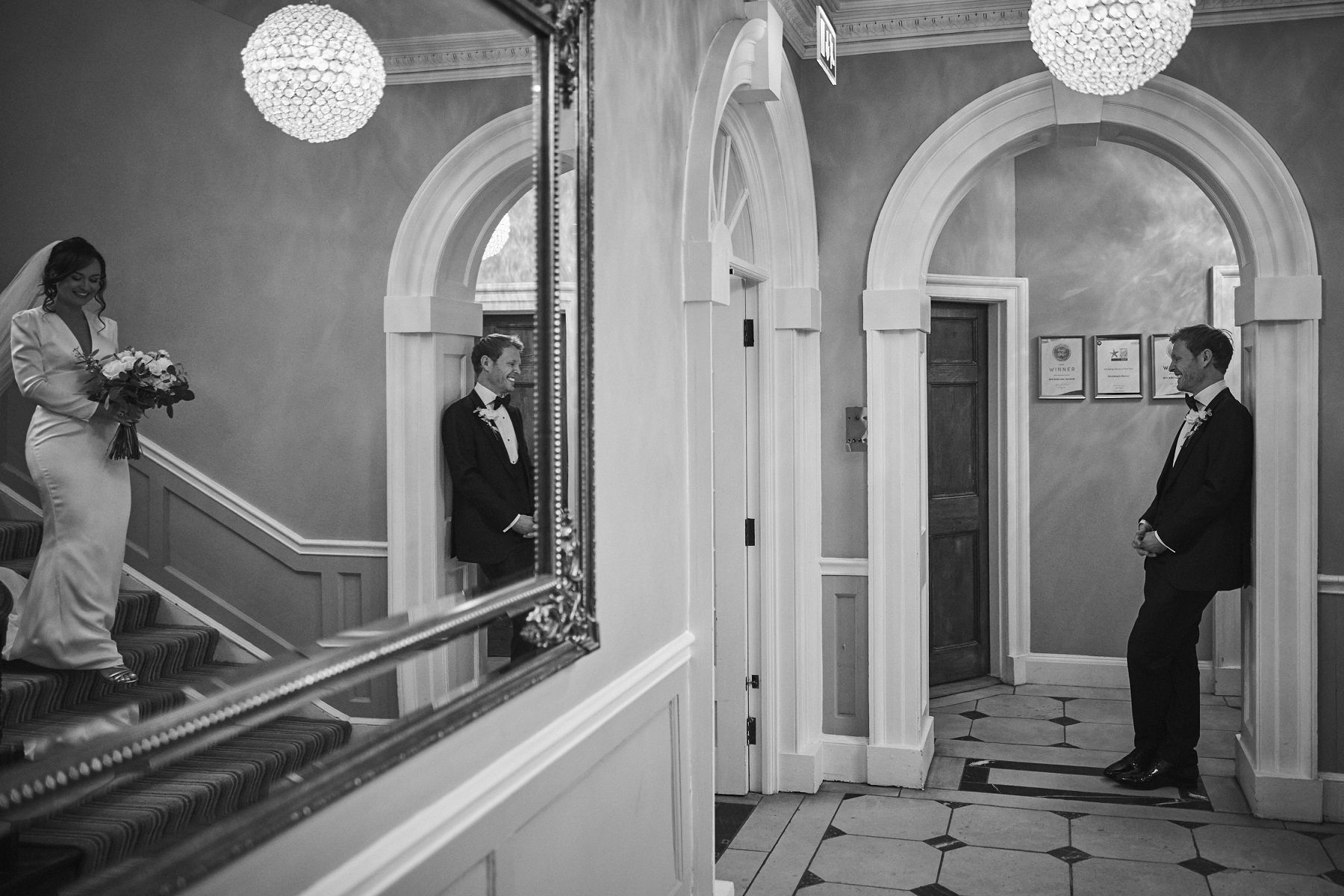 a bride in a wedding dress is holding a bouquet of flowers in a bedroom .