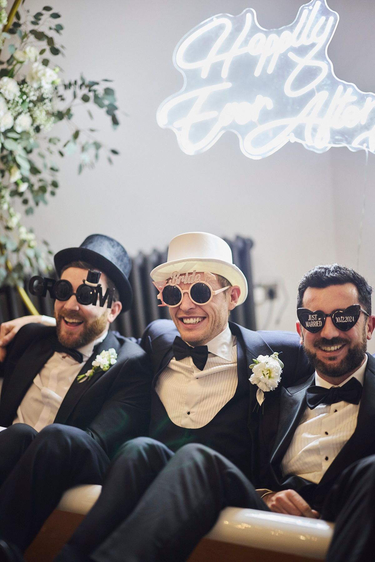 a bride and groom are standing in a grassy field .