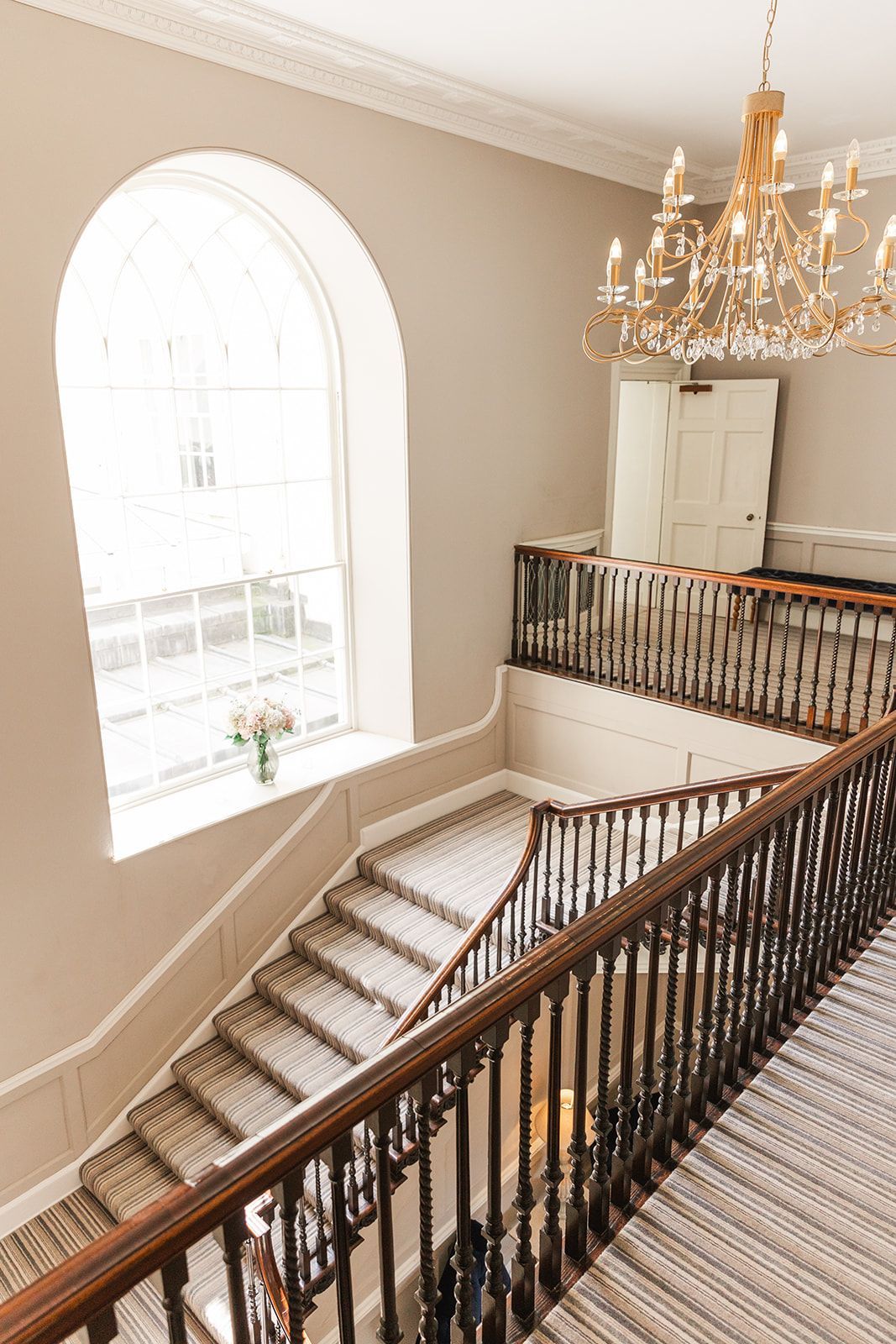 a bride and groom are posing for a picture in front of a large white building .