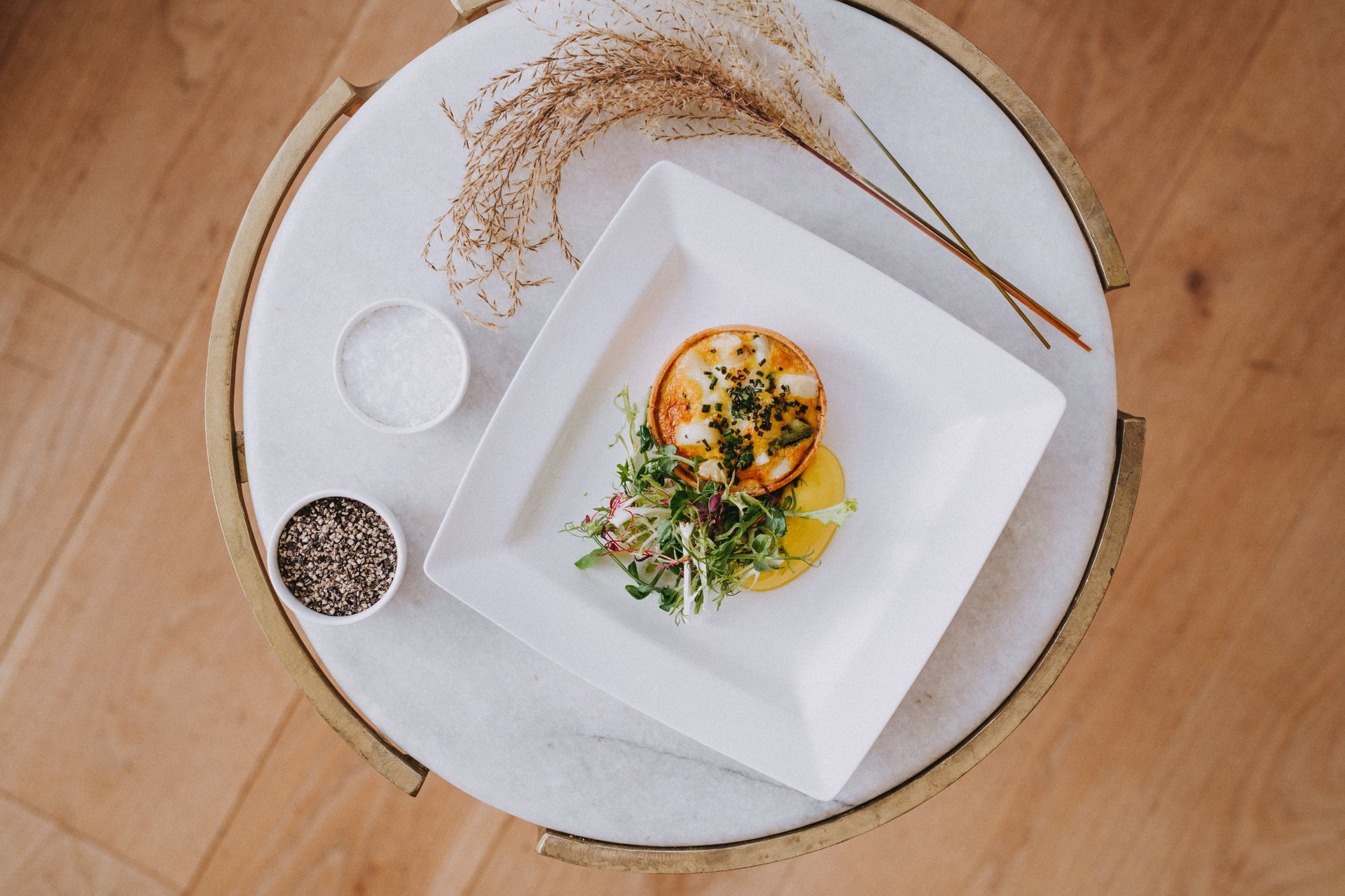 a plate of food is sitting on top of a marble table .
