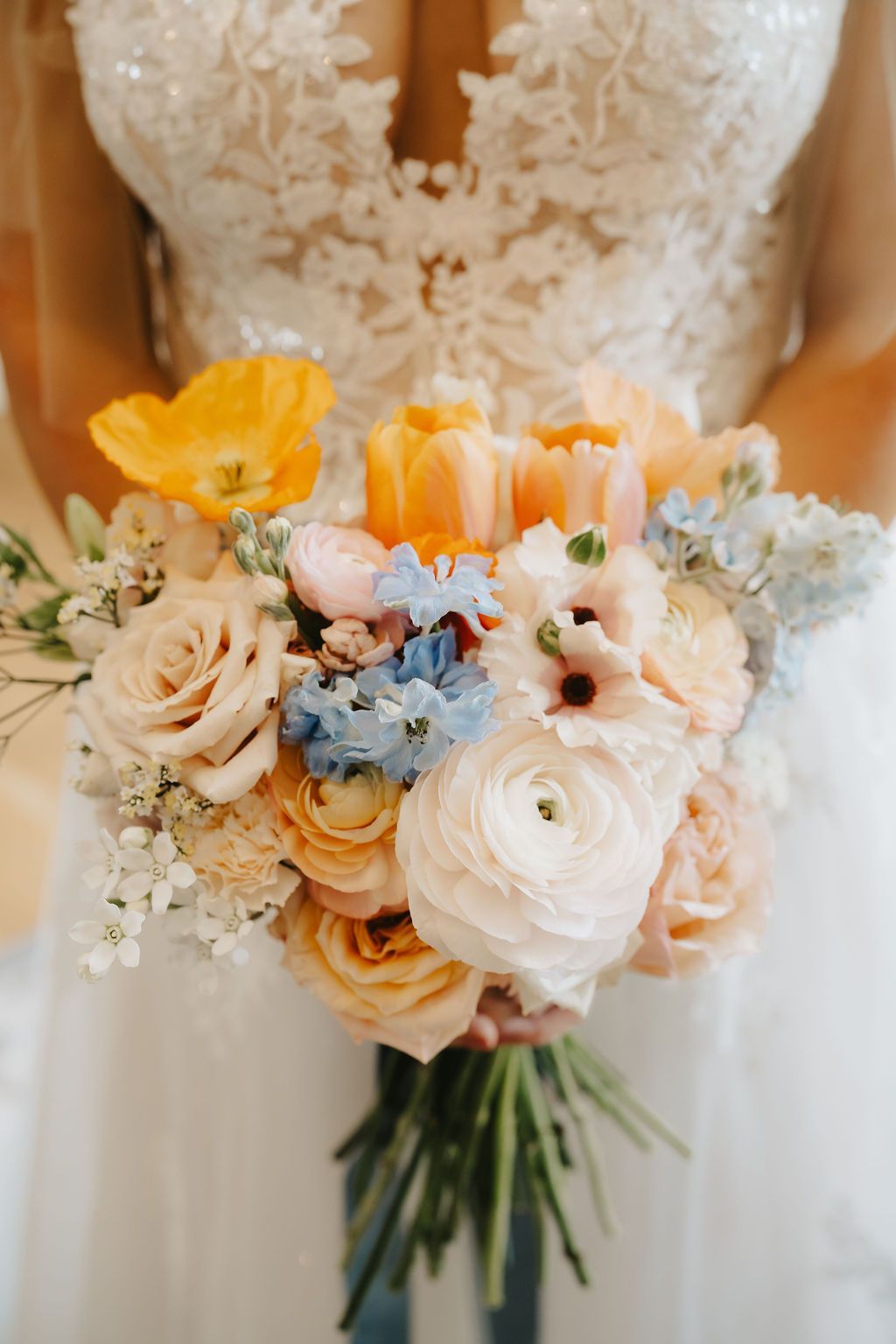 a bride in a wedding dress is holding a bouquet of flowers in a bedroom .