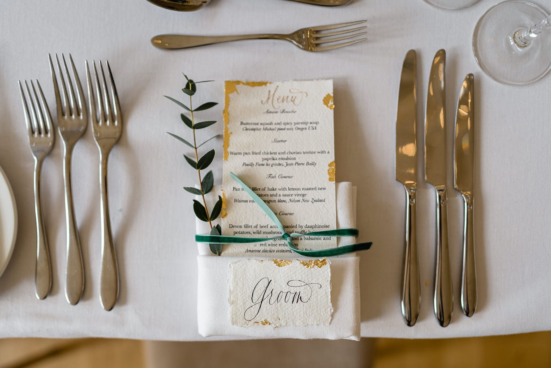 a table with silverware and a menu on it .
