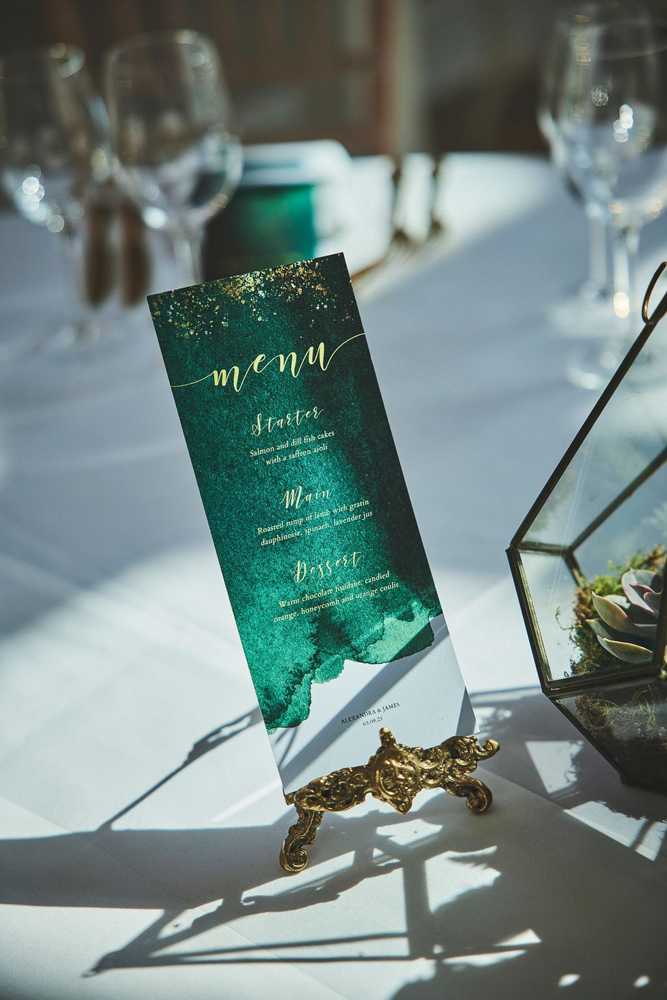 a menu is sitting on a table next to a terrarium.