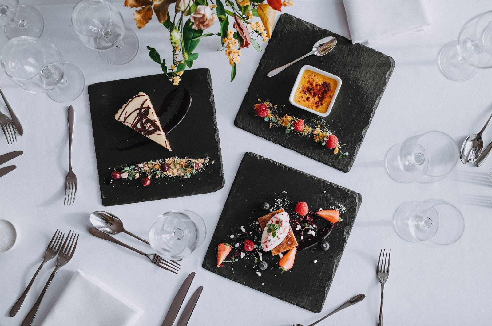 a table with plates of food and silverware on it