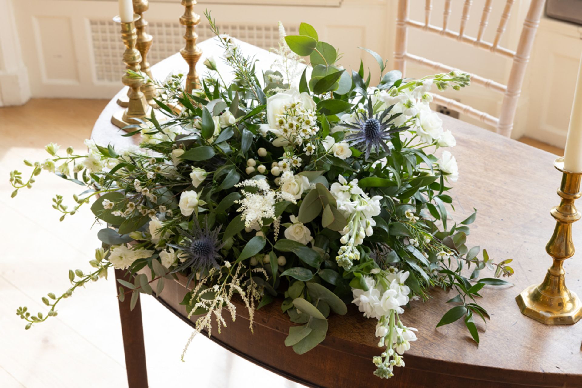 a table with a bunch of flowers and candles on it .
