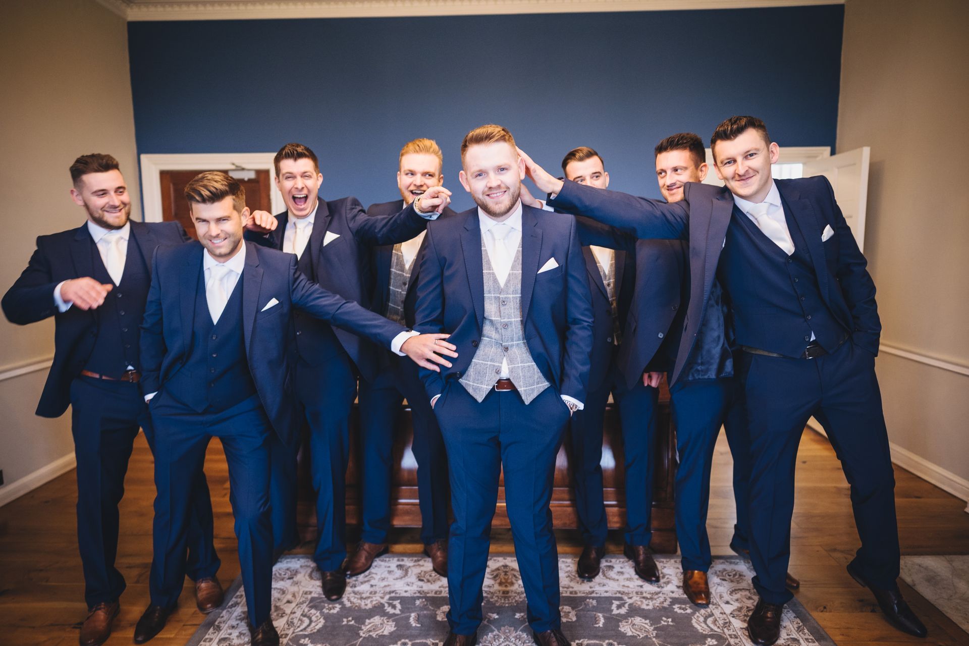 a group of men in suits are posing for a picture.