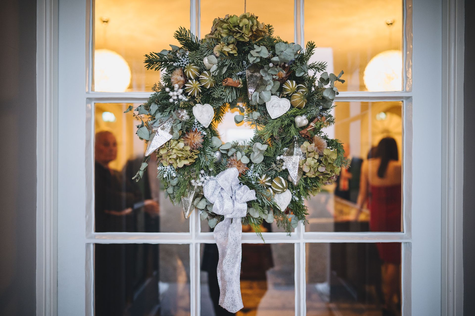 a wreath is hanging on a door in a room.