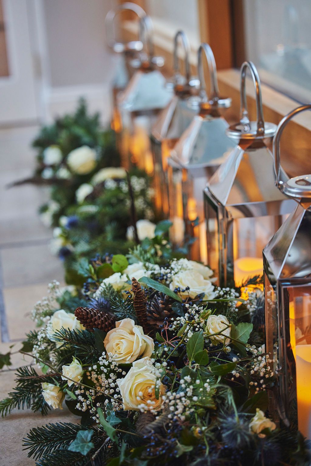 a row of lanterns decorated with flowers and candles .