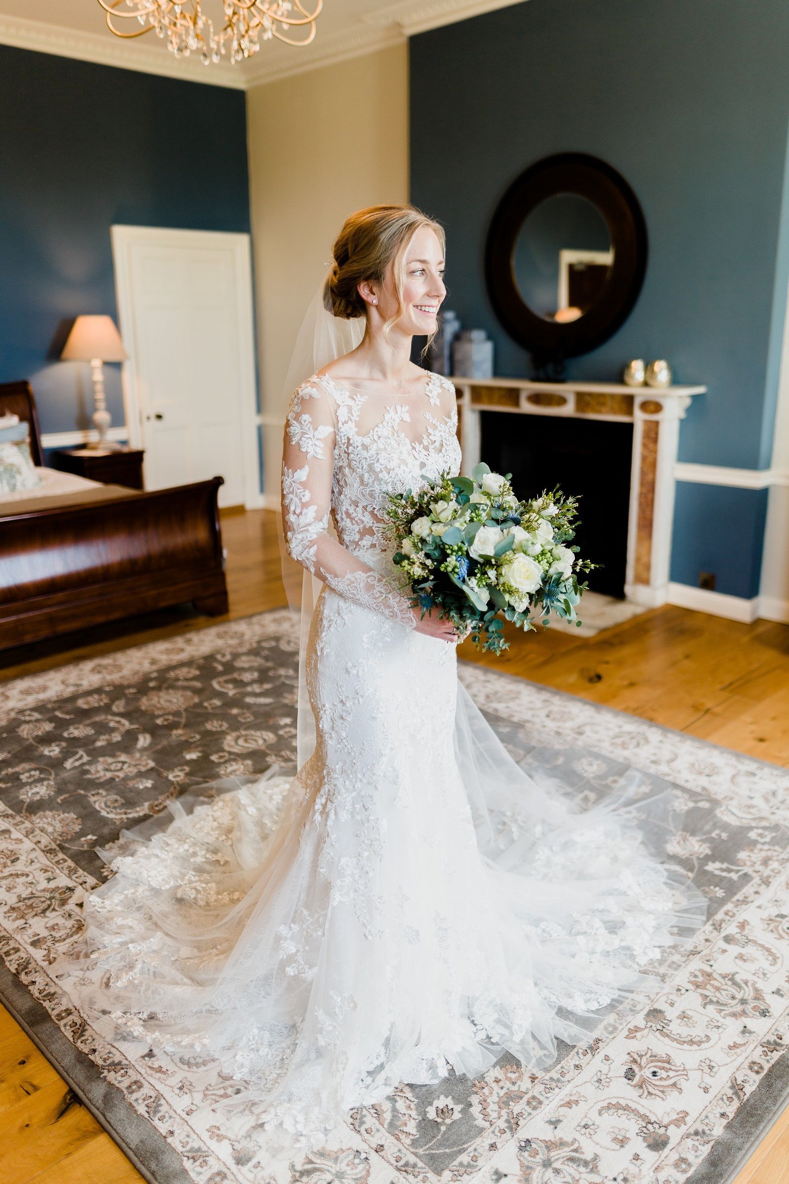a bride in a wedding dress is holding a bouquet of flowers in a room .