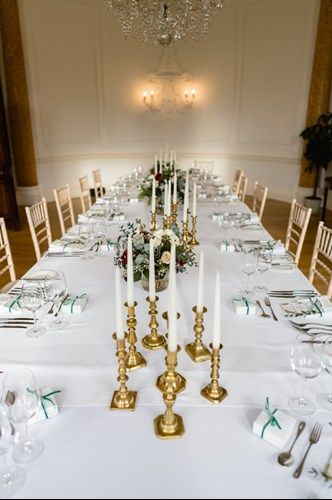 a long table with candles and flowers on it