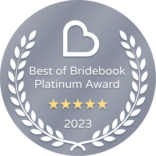 a badge that says `` best of bridebook platinum award '' with a heart and laurel wreath .