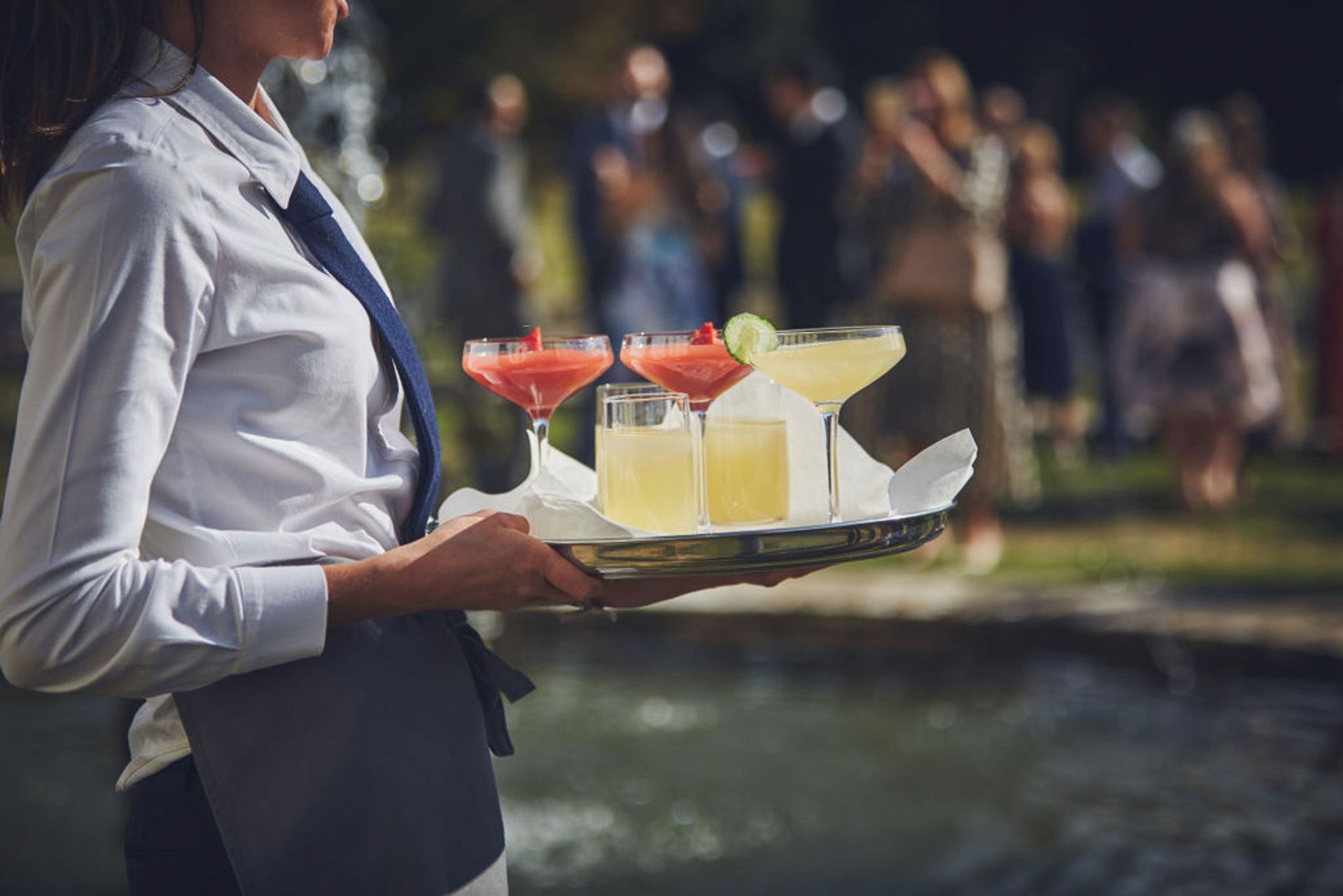 a woman is holding a tray of drinks in her hands .