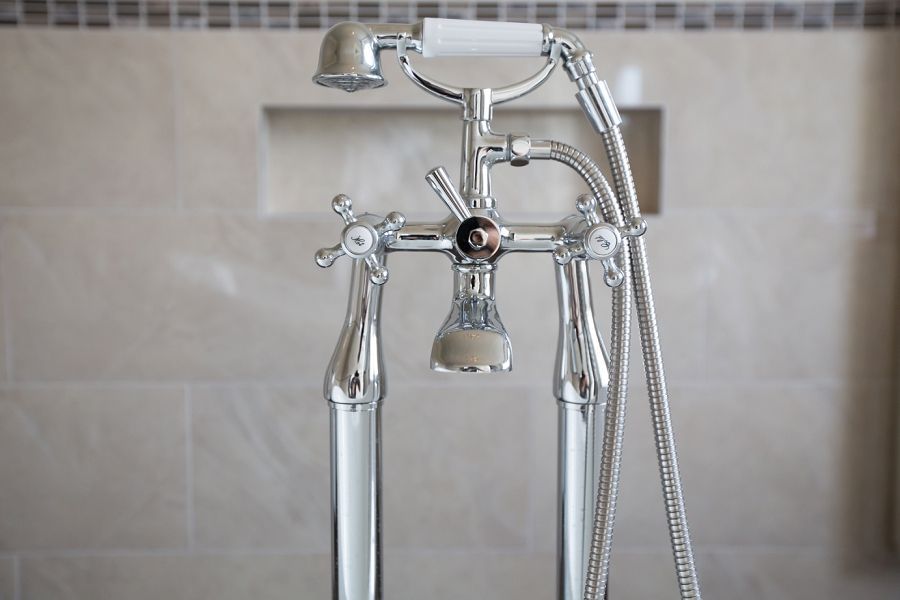 a bathroom faucet with a shower head attached to it