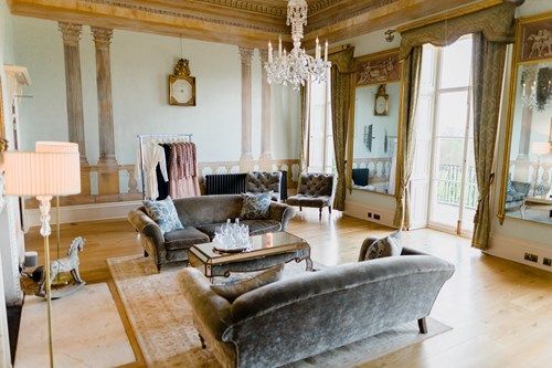 a living room filled with furniture and a chandelier .